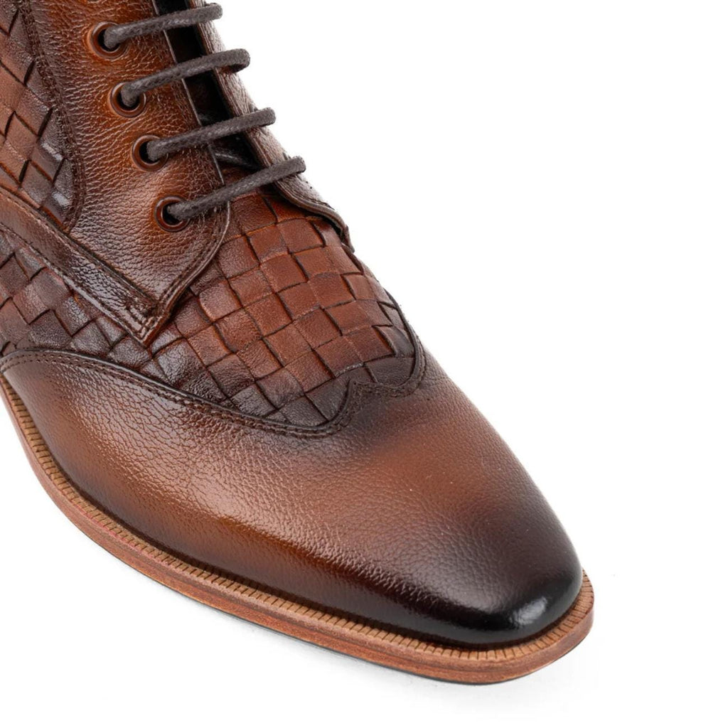 Brown men's leather ankle boot with woven leather accents, pointed toe, lace-up design, sturdy sole, fashionable casual footwear