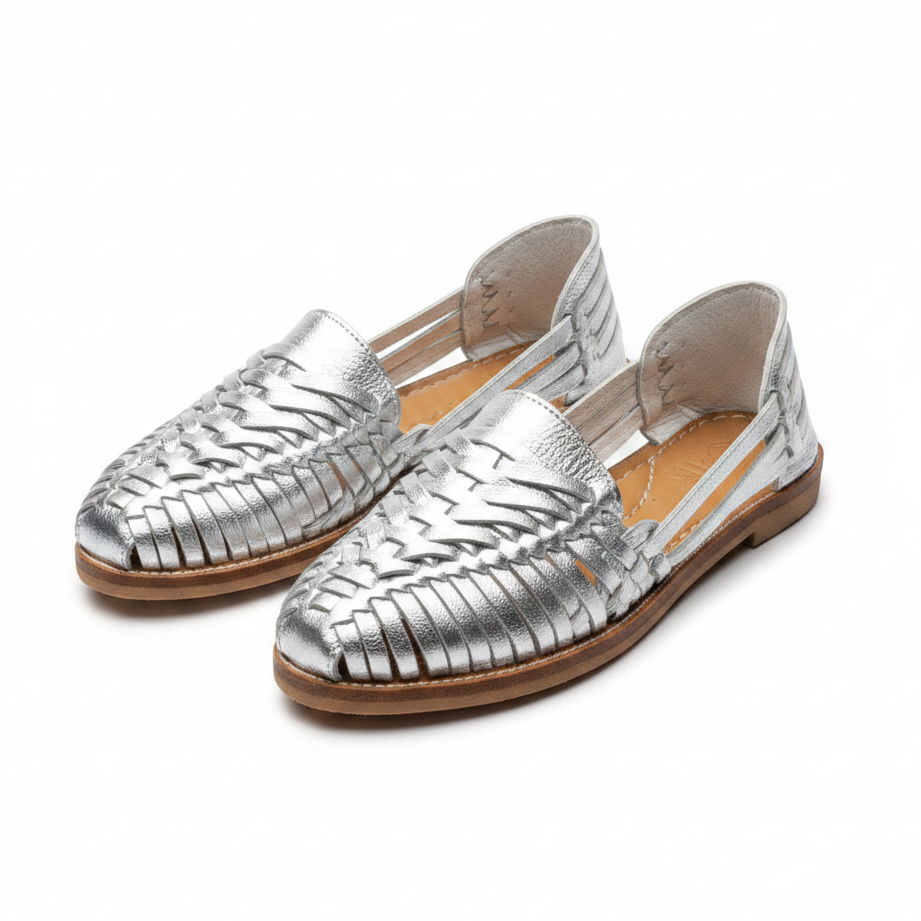 Handmade Mexican leather Huarache sandals by TAILOR LEATHER with woven straps and a flat sole, displayed on a neutral background.