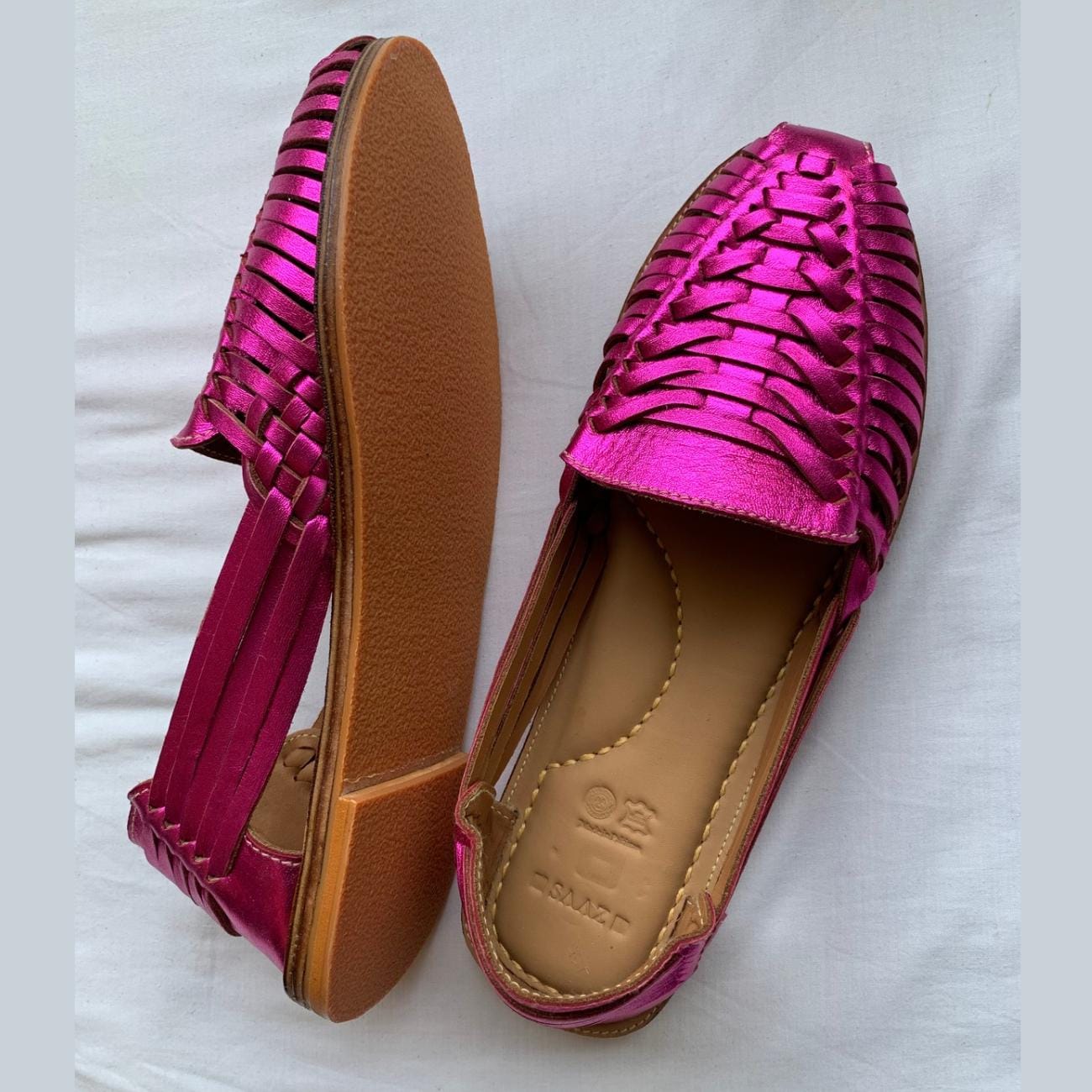 Handmade leather Mexican Huarache sandals by TAILOR LEATHER with woven straps and traditional design on a neutral background.